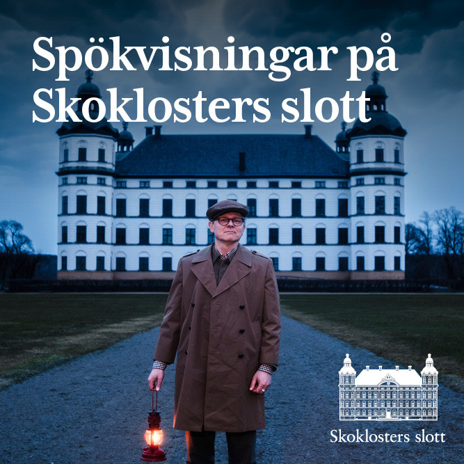 En man håller i en lykta med ett slott i bakgrunden.