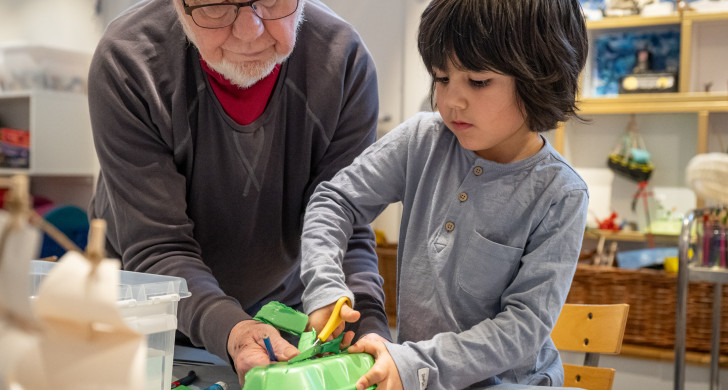 Vuxen och barnbarn skapar en båt tillsammans