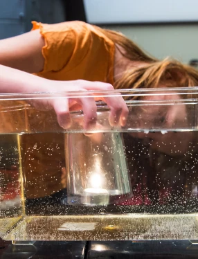 Flicka gör undervattenstest i balja.